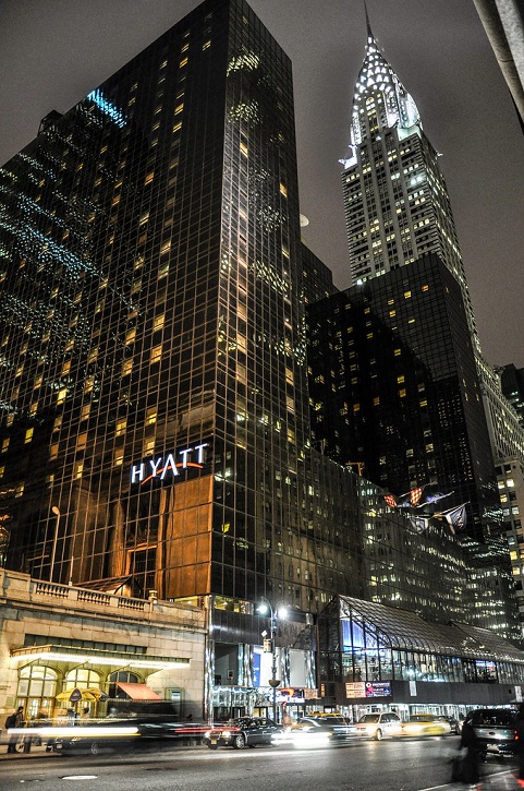 A large building with many windows lit up at night.