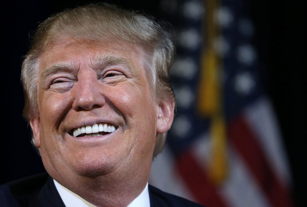 A close up of donald trump smiling for the camera