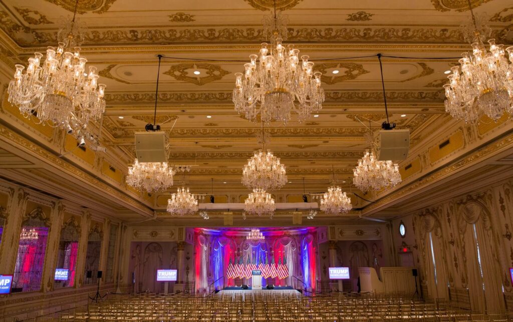 A large room with many chandeliers and a stage