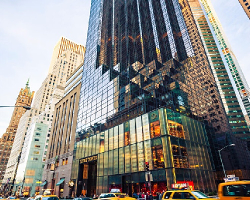 A city street with tall buildings and cars.